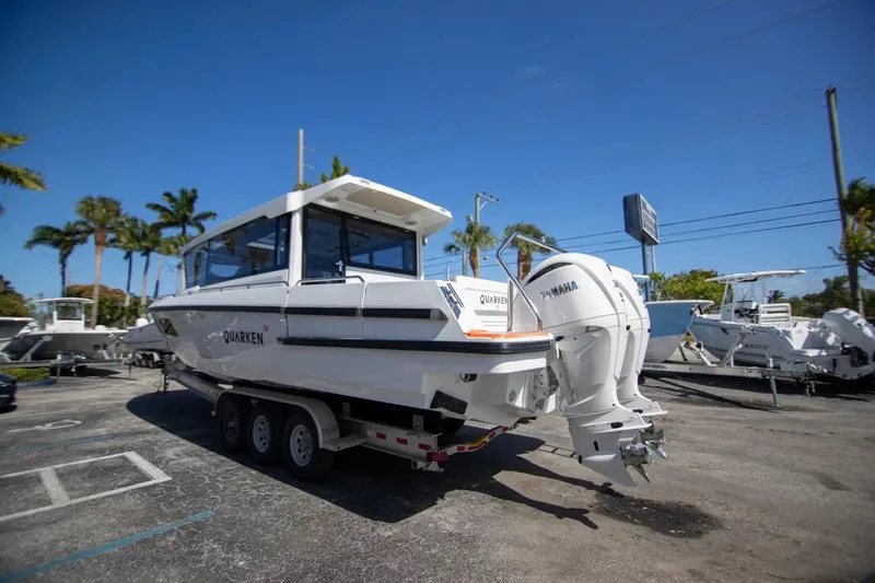  Yacht Photos Pics 2025 Quarken 35 Cabin boat on trailer with Yamaha engines, parked outdoors.