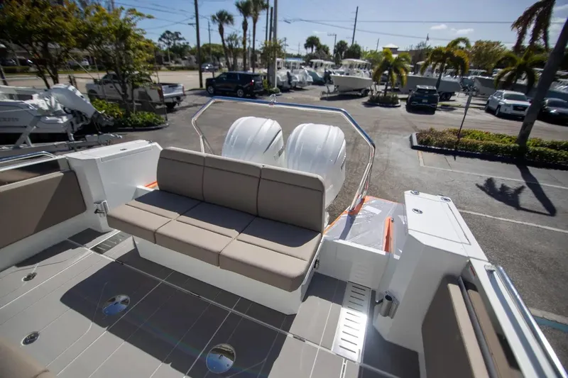  Yacht Photos Pics 2025 Quarken 35 Cabin boat with seating and dual engines in a marina setting.