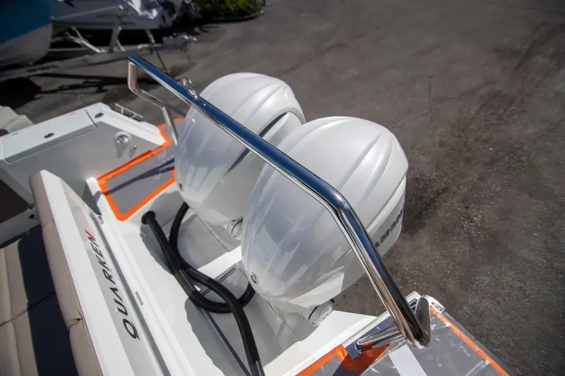  Yacht Photos Pics 2025 Quarken 35 Cabin boat with dual outboard engines and sleek chrome railing.
