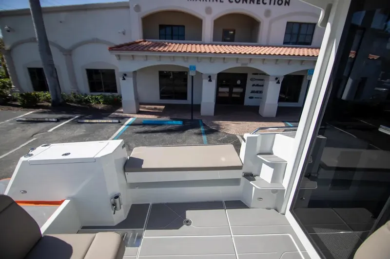  Yacht Photos Pics 2025 Quarken 35 Cabin boat interior with seating, docked near a marine building.