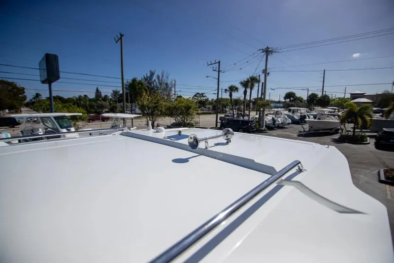  Yacht Photos Pics 2025 Quarken 35 Cabin boat roof view in a sunny marina setting.
