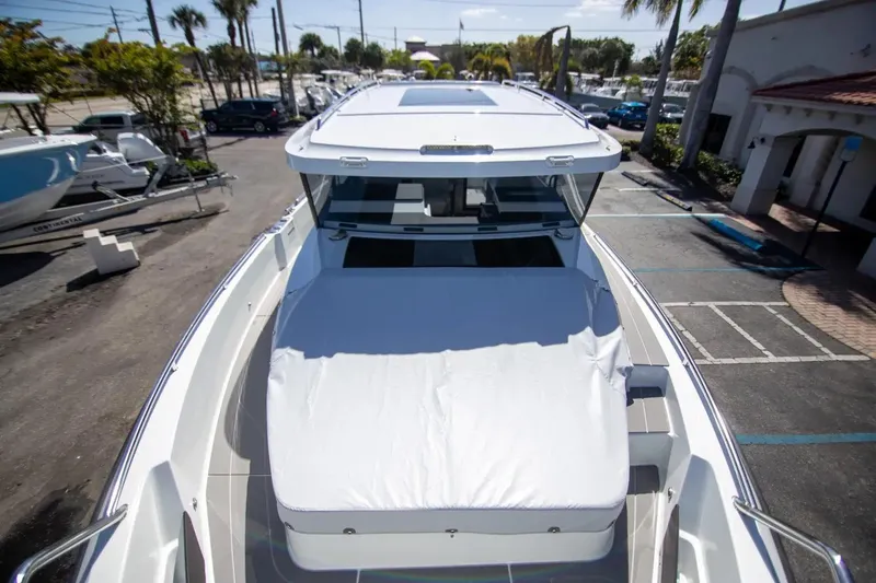  Yacht Photos Pics 2025 Quarken 35 Cabin boat, top view, docked in a sunny marina.