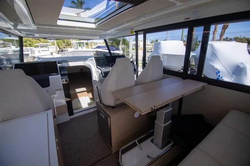  Yacht Photos Pics Interior of 2025 Quarken 35 Cabin boat with modern seating and skylight.