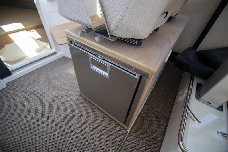  Yacht Photos Pics Interior of 2025 Quarken 35 Cabin featuring compact fridge and seating.
