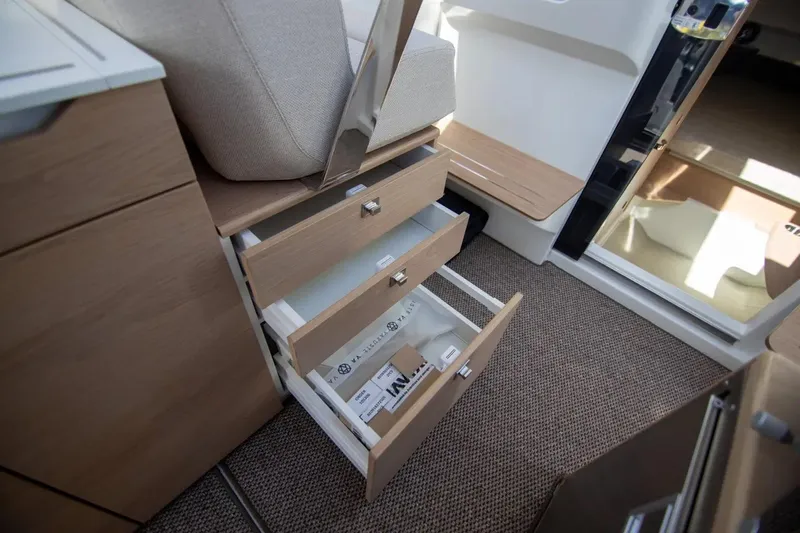  Yacht Photos Pics Interior of 2025 Quarken 35 Cabin showing open wooden drawers and carpeted floor.