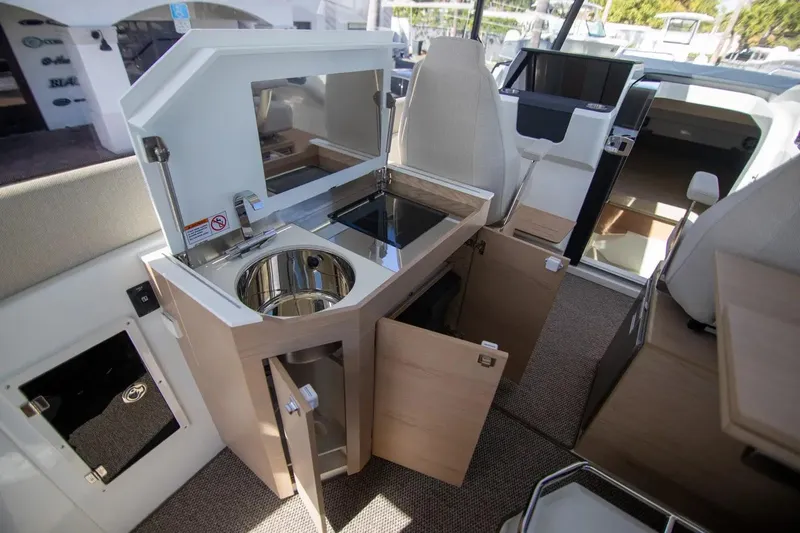  Yacht Photos Pics Interior of 2025 Quarken 35 Cabin featuring modern kitchenette with sink and storage.