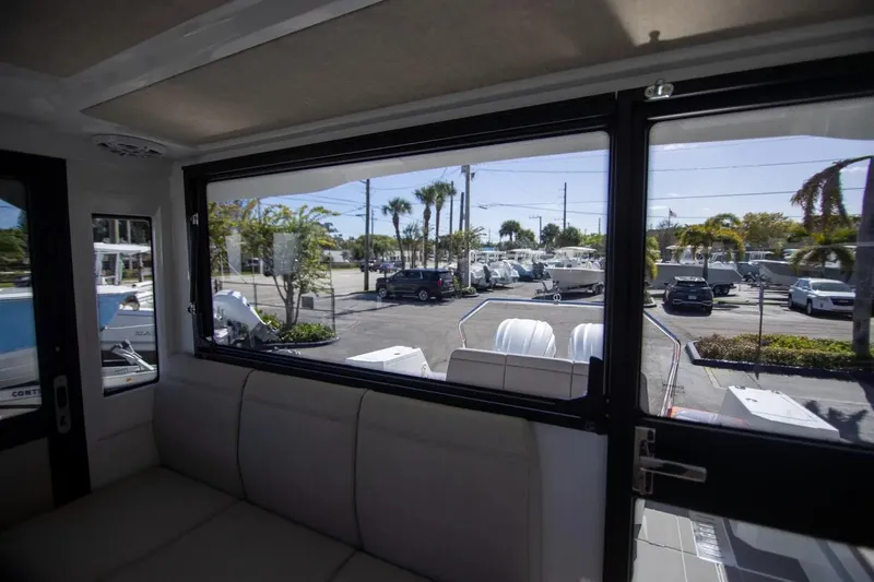  Yacht Photos Pics Interior view from Quarken 35 Cabin 2025, showcasing large window and outdoor parking area.