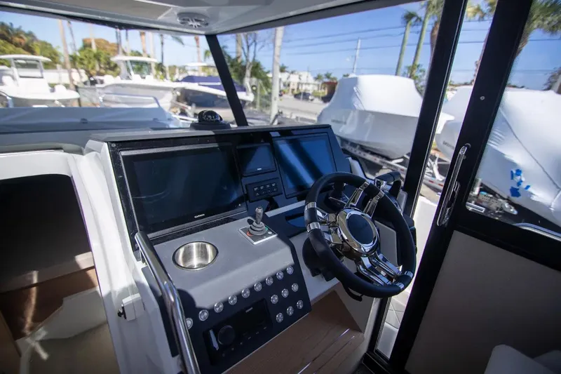  Yacht Photos Pics 2025 Quarken 35 Cabin boat interior with modern steering and control panel.