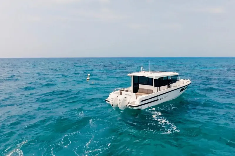  Yacht Photos Pics 2025 Quarken 35 Cabin boat cruising on open sea.