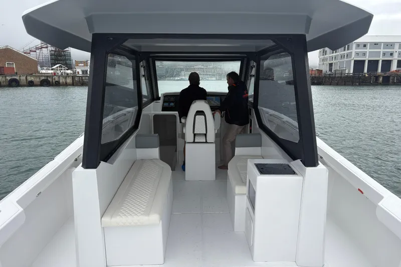 Hammercat 35hh Yacht Photos Pics Interior view of 2026 Hammer Yachts 35HH boat with two people at the helm.