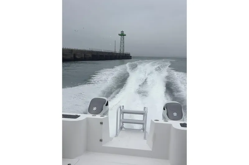 Hammercat 35hh Yacht Photos Pics 2026 Hammer Yachts 35HH cruising near a lighthouse, leaving a wake behind.