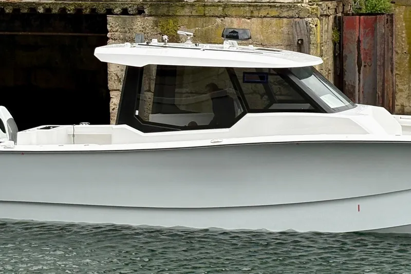 Hammercat 35hh Yacht Photos Pics 2026 Hammer Yachts 35HH boat docked near a stone wall.