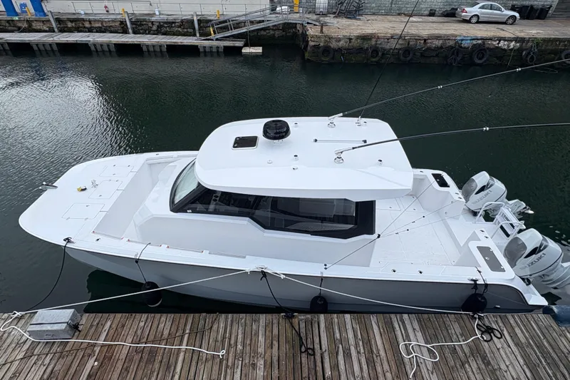 Hammercat 35hh Yacht Photos Pics 2026 Hammer Yachts 35HH docked, showcasing sleek design and dual outboard engines.