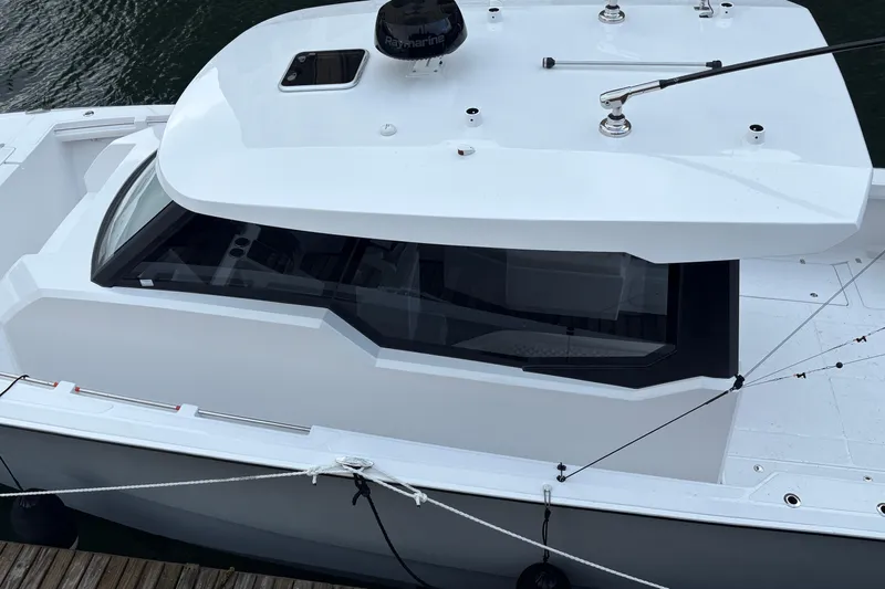 Hammercat 35hh Yacht Photos Pics 2026 Hammer Yachts 35HH, sleek white design, docked on calm water.