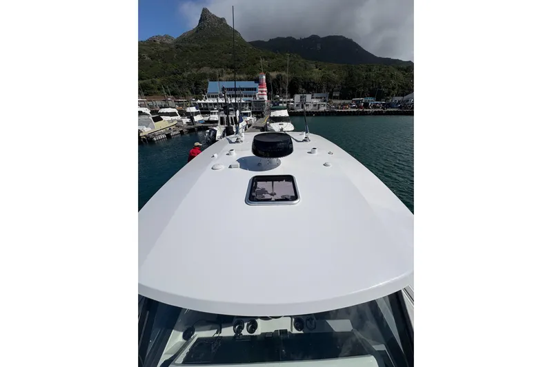 Hammercat 35hh Yacht Photos Pics 2026 Hammer Yachts 35HH docked in scenic marina with mountain backdrop.