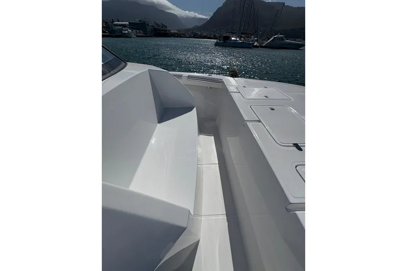 Hammercat 35hh Yacht Photos Pics 2026 Hammer Yachts 35HH boat deck with seating, docked in a scenic marina.