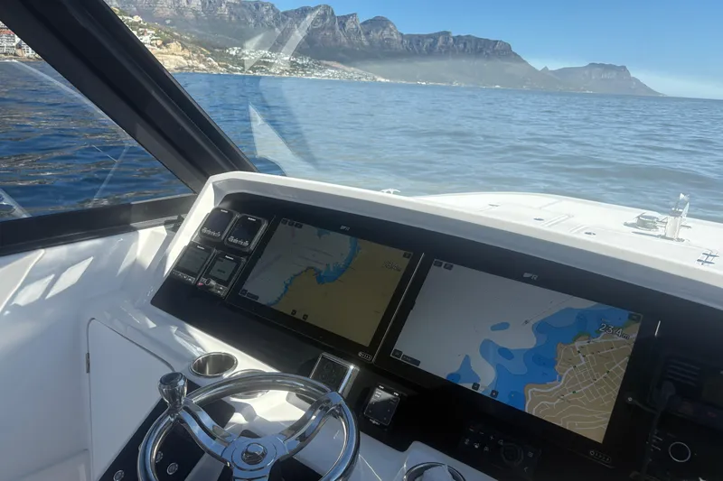 Hammercat 35hh Yacht Photos Pics Cockpit view of 2026 Hammer Yachts 35HH with navigation screens, steering wheel, and ocean backdrop.