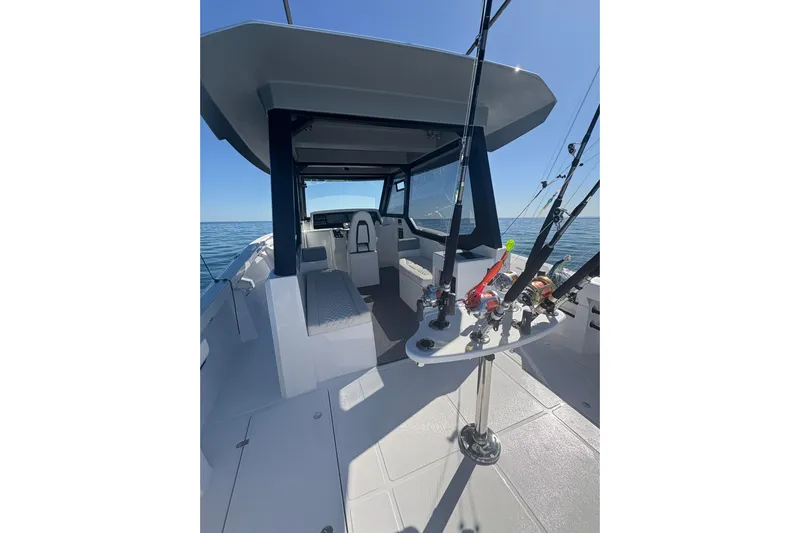 Hammercat 35hh Yacht Photos Pics 2026 Hammer Yachts 35HH boat interior with fishing rods, open sea view.