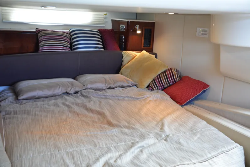  Yacht Photos Pics Cozy bedroom in 2012 Meridian 441 Sedan yacht with striped pillows and soft lighting.