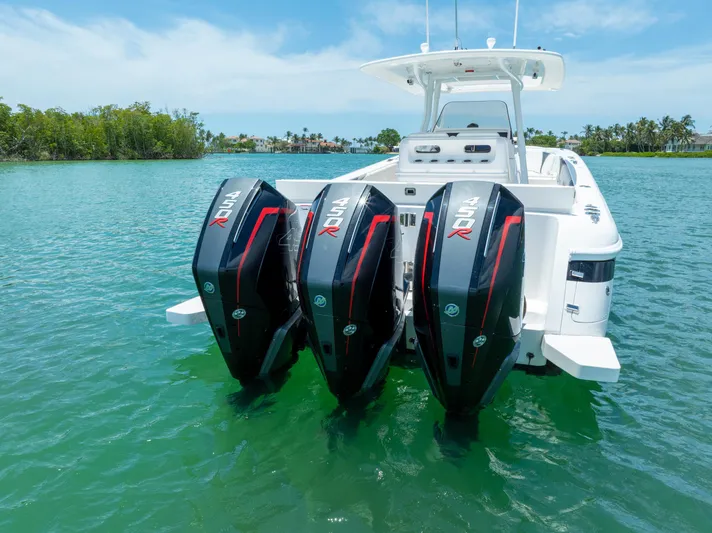 Freaky Fast Yacht Photos Pics 2018 Intrepid 375 Open boat with triple outboard engines on clear water.