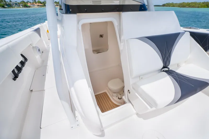 Freaky Fast Yacht Photos Pics 2018 Intrepid 375 Open boat interior with seating and compact toilet area.