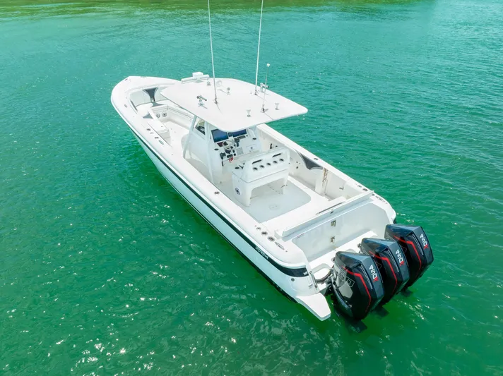 Freaky Fast Yacht Photos Pics 2018 Intrepid 375 Open boat with triple outboard engines on clear turquoise water.