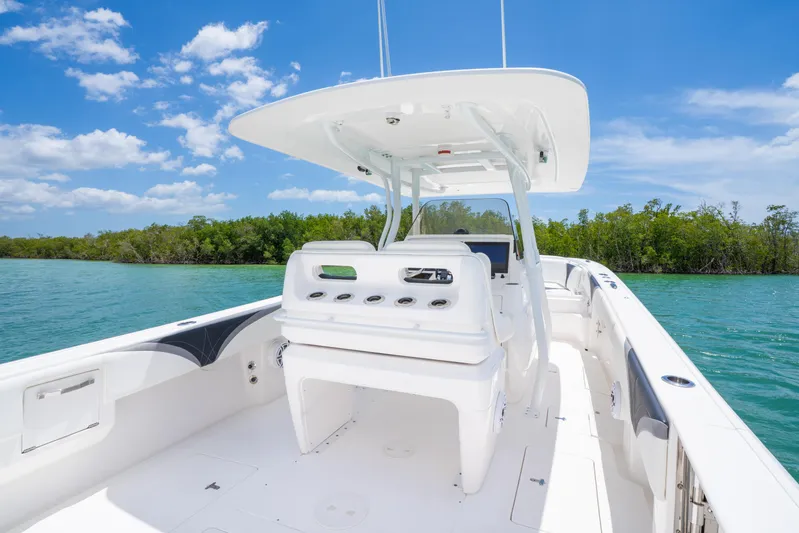 Freaky Fast Yacht Photos Pics 2018 Intrepid 375 Open boat on clear water, sunny day, lush greenery background.