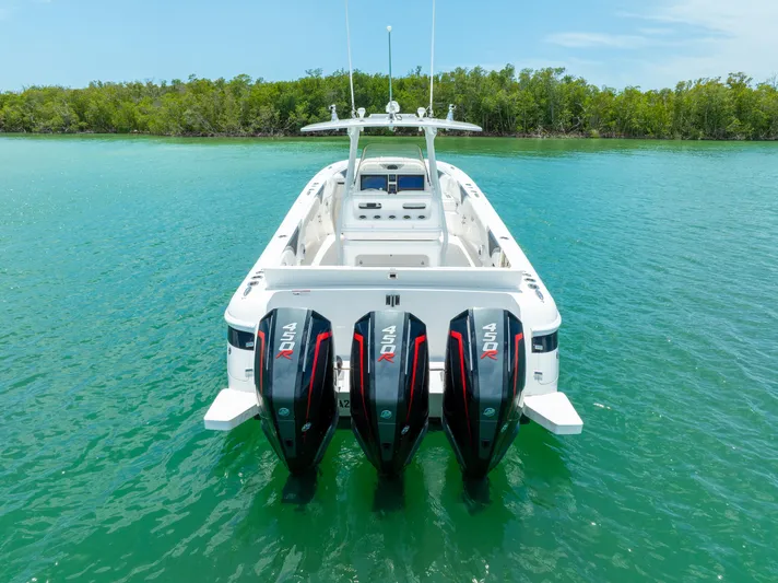 Freaky Fast Yacht Photos Pics 2018 Intrepid 375 Open boat with triple outboard engines on turquoise water.