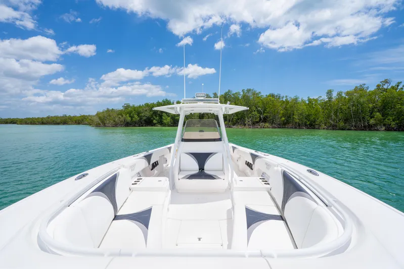 Freaky Fast Yacht Photos Pics 2018 Intrepid 375 Open boat on clear water with lush green shoreline.