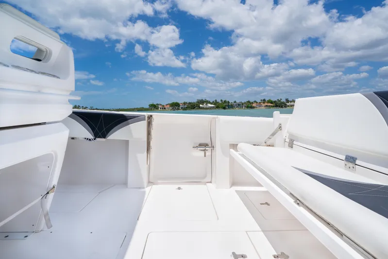 Freaky Fast Yacht Photos Pics 2018 Intrepid 375 Open boat interior with white seating, under a blue sky.