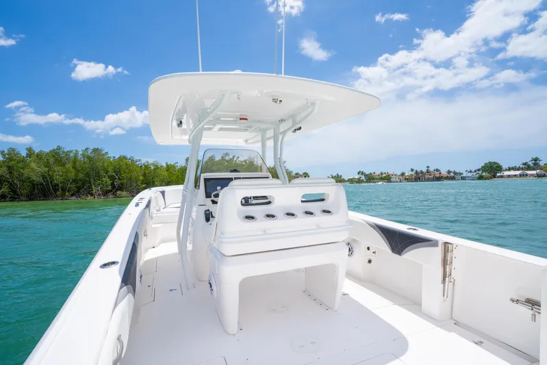 Freaky Fast Yacht Photos Pics 2018 Intrepid 375 Open boat on clear water, sunny day, lush greenery in background.
