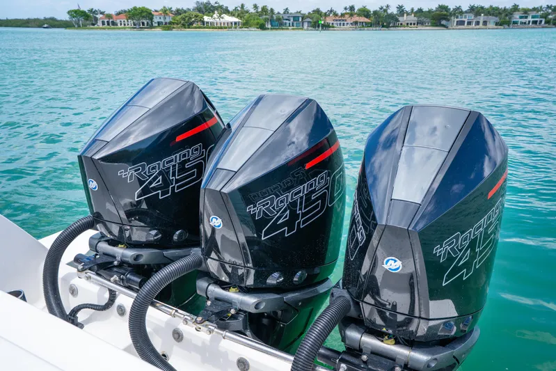 Freaky Fast Yacht Photos Pics Triple Mercury Racing 450R engines on a 2018 Intrepid 375 Open boat, docked by a scenic waterfront.