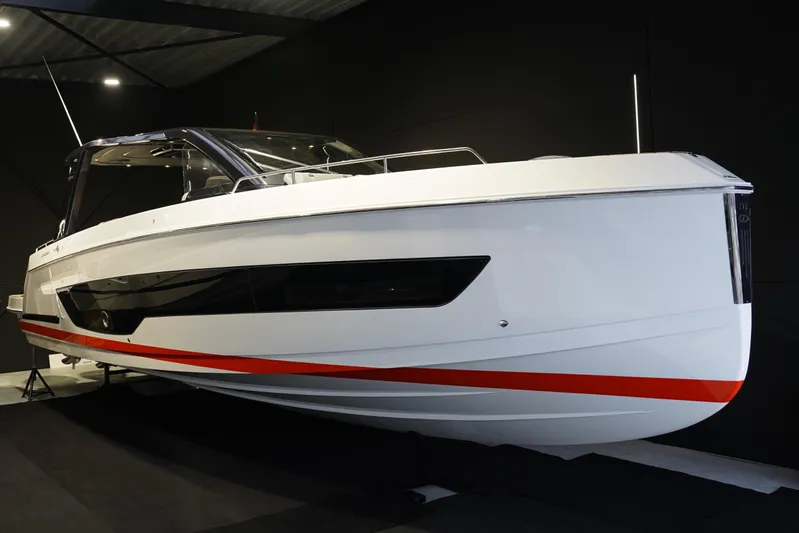  Yacht Photos Pics 2025 Schaefer V44 yacht with sleek design and red accent stripe in showroom.