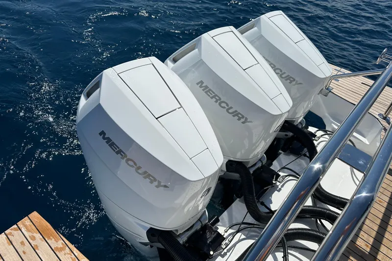  Yacht Photos Pics Triple Mercury outboard engines on 2025 Schaefer V44 yacht, cruising on blue ocean waters.
