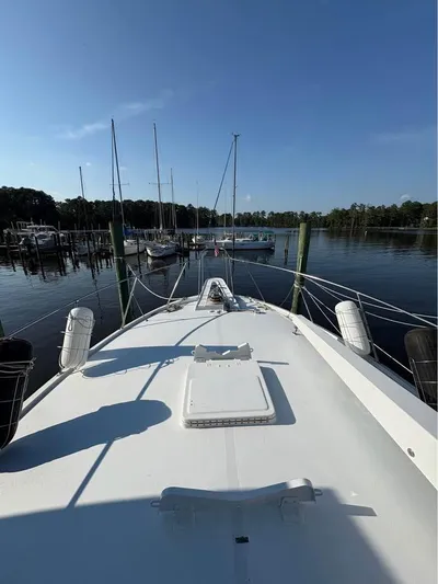 Shameless Yacht Photos Pics Bow view of 1983 Hatteras 46 Convertible yacht docked at marina.