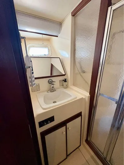 Shameless Yacht Photos Pics Bathroom interior of 1983 Hatteras 46 Convertible yacht with sink and shower.