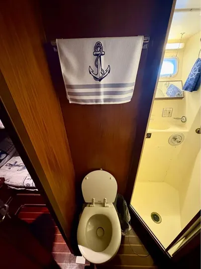 Shameless Yacht Photos Pics Bathroom in 1983 Hatteras 46 Convertible yacht with nautical-themed towel.