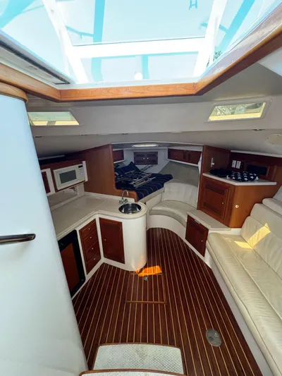 No Problem Yacht Photos Pics Interior of a 1998 Cabo 35 Express boat with wood flooring and modern amenities.