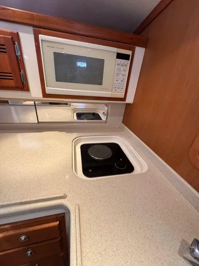 No Problem Yacht Photos Pics 1998 Cabo 35 Express yacht kitchen with microwave and stovetop.