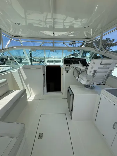 No Problem Yacht Photos Pics 1998 Cabo 35 Express boat interior with helm, seating, and open cabin door.