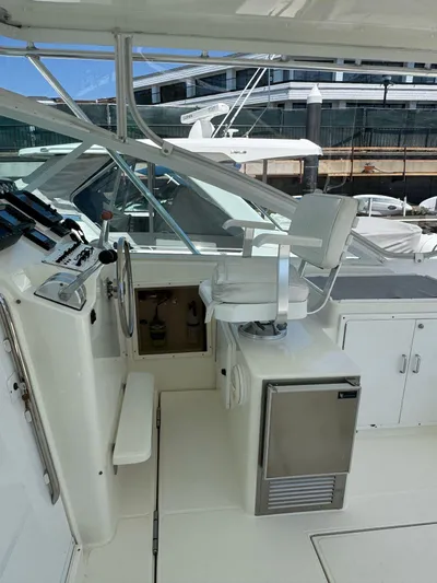 No Problem Yacht Photos Pics 1998 Cabo 35 Express boat cockpit with captain's chair and control panel.