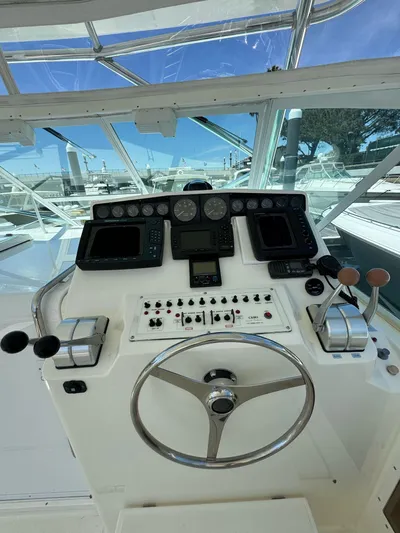No Problem Yacht Photos Pics 1998 Cabo 35 Express helm with steering wheel, controls, and navigation instruments.