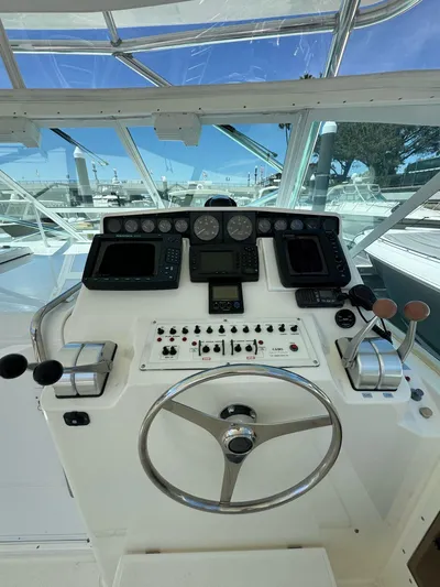 No Problem Yacht Photos Pics 1998 Cabo 35 Express helm with navigation instruments and steering wheel.