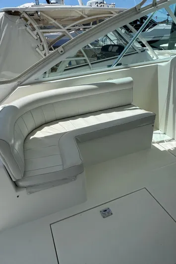 No Problem Yacht Photos Pics 1998 Cabo 35 Express boat interior with white seating and sleek design.