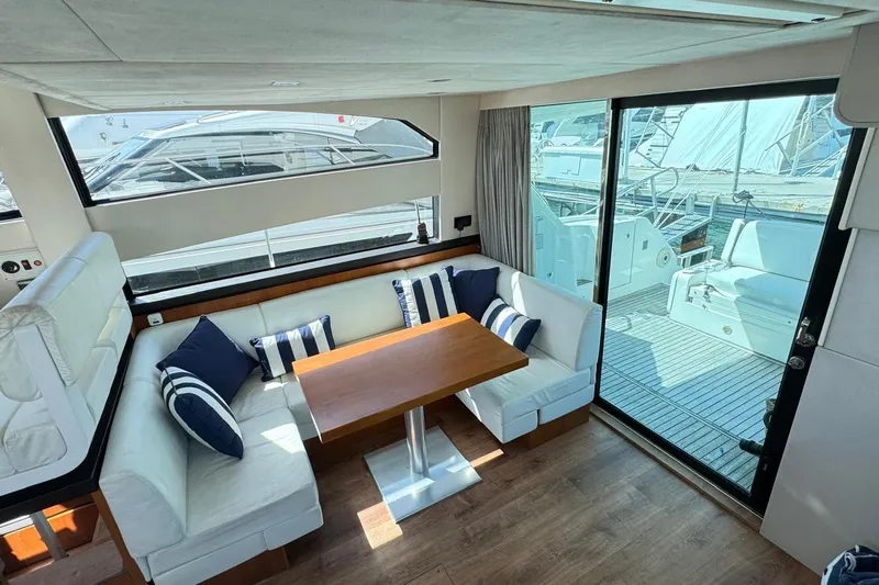  Yacht Photos Pics Interior salon with cozy seating and wooden table.