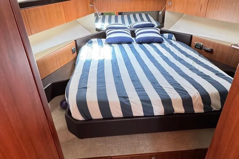  Yacht Photos Pics Luxurious cabin interior of 2013 Fairline Squadron 42 yacht with striped bedding.