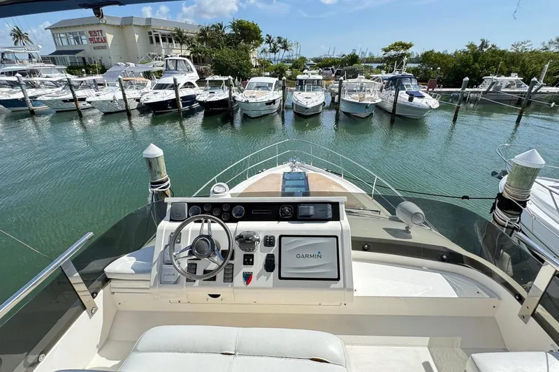  Yacht Photos Pics 2013 Fairline Squadron 42 yacht helm with marina view, featuring Garmin navigation system.