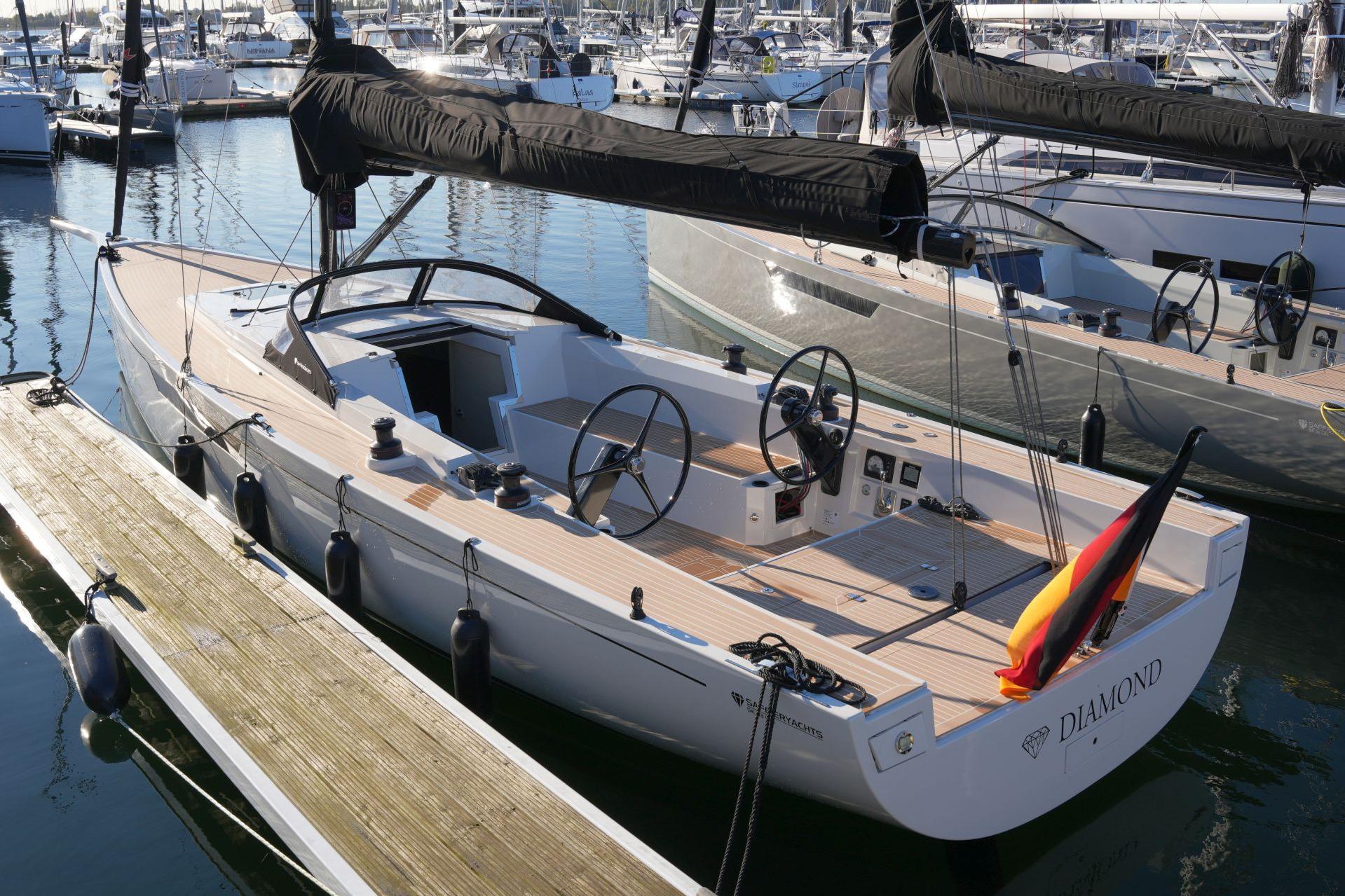 2023 Saffier SE 33 Life sailboat docked in marina, featuring sleek design and modern amenities.