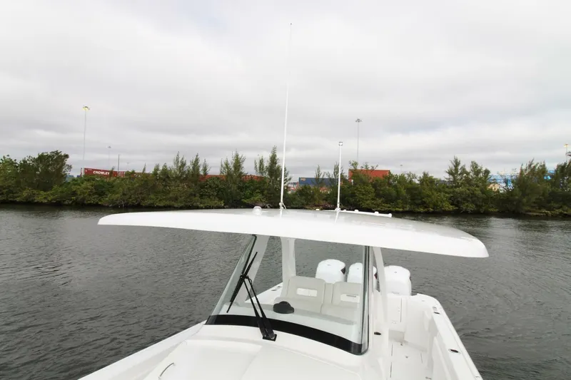  Yacht Photos Pics 2024 Intrepid 375 Nomad SE boat on calm water, featuring sleek design and spacious deck.