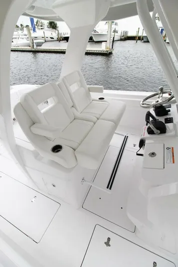  Yacht Photos Pics 2024 Intrepid 375 Nomad SE boat interior with white seating and steering console.